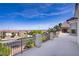 Open deck featuring a wrought iron fence overlooking desert landscape and blue sky, perfect for entertaining at 4012 Owlshead Mountain St, Las Vegas, NV 89129