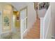 Hallway with a staircase, wall decor, and entrances leading to multiple rooms, offers a functional living space at 4012 Owlshead Mountain St, Las Vegas, NV 89129