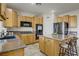 Functional kitchen with ample cabinet space, stone countertops, stainless steel appliances and an island at 4012 Owlshead Mountain St, Las Vegas, NV 89129