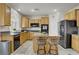 Bright kitchen with an island, stainless steel appliances, and wood cabinetry at 4012 Owlshead Mountain St, Las Vegas, NV 89129