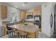 Open kitchen featuring an island, wood cabinets, and modern appliances at 4012 Owlshead Mountain St, Las Vegas, NV 89129