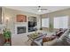 Cozy living room with fireplace, carpeted floors, large windows and comfortable seating at 4012 Owlshead Mountain St, Las Vegas, NV 89129