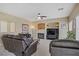 Cozy living room featuring a fireplace, comfortable seating, and a bright atmosphere at 4012 Owlshead Mountain St, Las Vegas, NV 89129