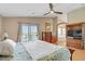 Bedroom featuring a ceiling fan, balcony access, and an ensuite bathroom at 4012 Owlshead Mountain St, Las Vegas, NV 89129