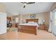 This bedroom is spacious with a ceiling fan, and a desk and chair at 4012 Owlshead Mountain St, Las Vegas, NV 89129
