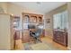 A bright home office features a computer desk, bookcase, and natural light at 4012 Owlshead Mountain St, Las Vegas, NV 89129