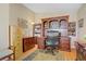 A spacious home office features wooden furniture, ample storage, and a comfortable work space at 4012 Owlshead Mountain St, Las Vegas, NV 89129