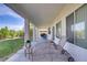Relaxing covered patio with lounge chairs and views of the backyard's well-maintained lawn at 4012 Owlshead Mountain St, Las Vegas, NV 89129