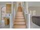 Bright stairway leading to the upper level with wood stairs and white railings at 4012 Owlshead Mountain St, Las Vegas, NV 89129