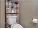 Efficiently designed half bath featuring a modern toilet and compact shelving for storage at 4012 Owlshead Mountain St, Las Vegas, NV 89129