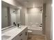 Bathroom with a double sink vanity with a faux marble top, and a tiled shower-tub combination at 4388 Cave Lake Ave, North Las Vegas, NV 89032