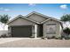 Charming single-story home featuring a gray stucco exterior, well-maintained landscaping, and an attached two-car garage at 4396 Cave Lake Ave, North Las Vegas, NV 89032