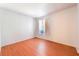 Bright bedroom with window and wood floor; clean and simple design at 4687 Monterey Cir # 1, Las Vegas, NV 89169