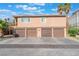 Exterior shot of garages for parking with a few trees at 4687 Monterey Cir # 1, Las Vegas, NV 89169