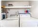Laundry room with modern washer and dryer and overhead shelf at 4687 Monterey Cir # 1, Las Vegas, NV 89169
