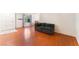 Spacious living room featuring wood floors, large windows, and a comfortable sofa at 4687 Monterey Cir # 1, Las Vegas, NV 89169