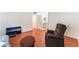 Comfortable living area featuring a recliner, TV, and wood-look flooring at 4687 Monterey Cir # 1, Las Vegas, NV 89169