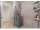 Updated shower with a curtain and modern fixtures, plus storage shelves at 4687 Monterey Cir # 1, Las Vegas, NV 89169
