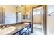 Bathroom with double sinks, granite countertop, and a separate tub and shower at 524 Blanche Ct, Henderson, NV 89052
