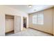 Carpeted bedroom with closet and access to private bathroom and a large window at 524 Blanche Ct, Henderson, NV 89052