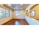 Second floor landing area with hardwood floors, decorative columns, and many windows at 524 Blanche Ct, Henderson, NV 89052