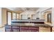 Kitchen featuring a large breakfast bar with stainless steel appliances and granite countertops at 524 Blanche Ct, Henderson, NV 89052