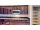 Contemporary kitchen featuring dark cabinets, gas cooktop, and granite countertops at 524 Blanche Ct, Henderson, NV 89052