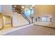Open living area featuring a staircase, and carpet and tile flooring at 524 Blanche Ct, Henderson, NV 89052