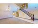 Open living area with carpet, tile flooring, chandelier, stairway and many windows at 524 Blanche Ct, Henderson, NV 89052