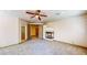 Spacious living room featuring a cozy fireplace and ceiling fan at 524 Blanche Ct, Henderson, NV 89052