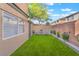 Private backyard features well-kept artificial turf and comfortable seating area at 601 Bear Grass St, Las Vegas, NV 89144