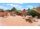 Inviting backyard patio with outdoor seating surrounding a cozy brick fireplace feature at 601 Bear Grass St, Las Vegas, NV 89144