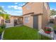 Spacious backyard with artificial turf, covered patio, and a convenient side entrance at 601 Bear Grass St, Las Vegas, NV 89144