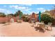 Inviting backyard patio with outdoor seating surrounding a cozy brick fireplace feature at 601 Bear Grass St, Las Vegas, NV 89144