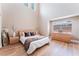 Bright bedroom features high ceilings, light wood floors, a large window, and modern decor at 601 Bear Grass St, Las Vegas, NV 89144