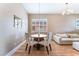 Elegant dining area adjacent to the living room, showcasing a modern light fixture and stylish decor at 601 Bear Grass St, Las Vegas, NV 89144
