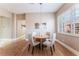 Inviting dining area with natural light, modern lighting, and sleek hardwood floors at 601 Bear Grass St, Las Vegas, NV 89144