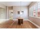 Dining area featuring hardwood floors, neutral color palette, and large window for natural light at 601 Bear Grass St, Las Vegas, NV 89144