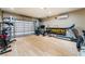 Converted garage with exercise equipment featuring wood flooring and garage door access at 601 Bear Grass St, Las Vegas, NV 89144