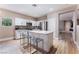 Contemporary kitchen featuring white cabinets, stainless steel appliances, and a granite countertop island at 601 Bear Grass St, Las Vegas, NV 89144