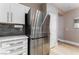 Modern kitchen featuring stainless steel fridge, granite counters, and white cabinets at 601 Bear Grass St, Las Vegas, NV 89144