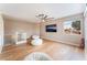 Second story living room featuring wood laminate floors, white couches, and a ceiling fan and a TV at 601 Bear Grass St, Las Vegas, NV 89144