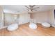 Upstairs living room featuring wood laminate floors, white couches, and a ceiling fan at 601 Bear Grass St, Las Vegas, NV 89144