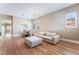 Bright and airy living room featuring hardwood floors, modern lighting, and comfortable furnishings at 601 Bear Grass St, Las Vegas, NV 89144