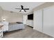 Bedroom with wood-look floors, a ceiling fan, and a mounted TV at 608 W Mcdermit St, Las Vegas, NV 89107