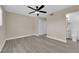 Bedroom with new laminate flooring, a ceiling fan, and an ensuite bathroom at 608 W Mcdermit St, Las Vegas, NV 89107