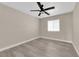 A vacant bedroom with a ceiling fan, wood-look floors, and a window at 608 W Mcdermit St, Las Vegas, NV 89107