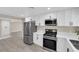Stylish kitchen showcasing stone countertops, a stainless steel refrigerator, and modern appliances at 608 W Mcdermit St, Las Vegas, NV 89107