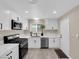 Bright, updated kitchen with stainless steel appliances, stone countertops and matching cabinets at 608 W Mcdermit St, Las Vegas, NV 89107