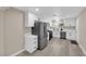 Beautiful kitchen featuring stainless steel appliances, modern white cabinets, and lovely laminate flooring at 608 W Mcdermit St, Las Vegas, NV 89107